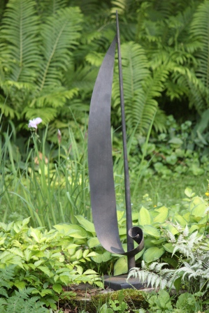 The sailboat that Harold made (garage Blacksmith!) for one of Betty's flower show competitions!  It is beautiful in the garden.