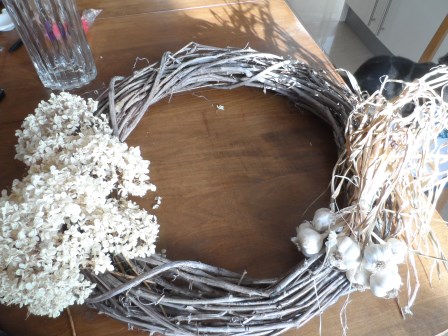 Adding garlic and Annabelle Hydrangea to wreath