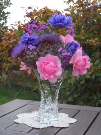 Artichokes, Mr. Fokker anemone, erysimum (bowles' mauve), and pink roses