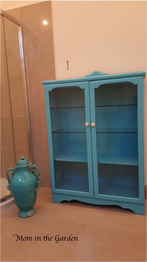 glass door cabinet painted turquoise 