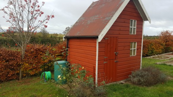 side view of playhouse with water butt