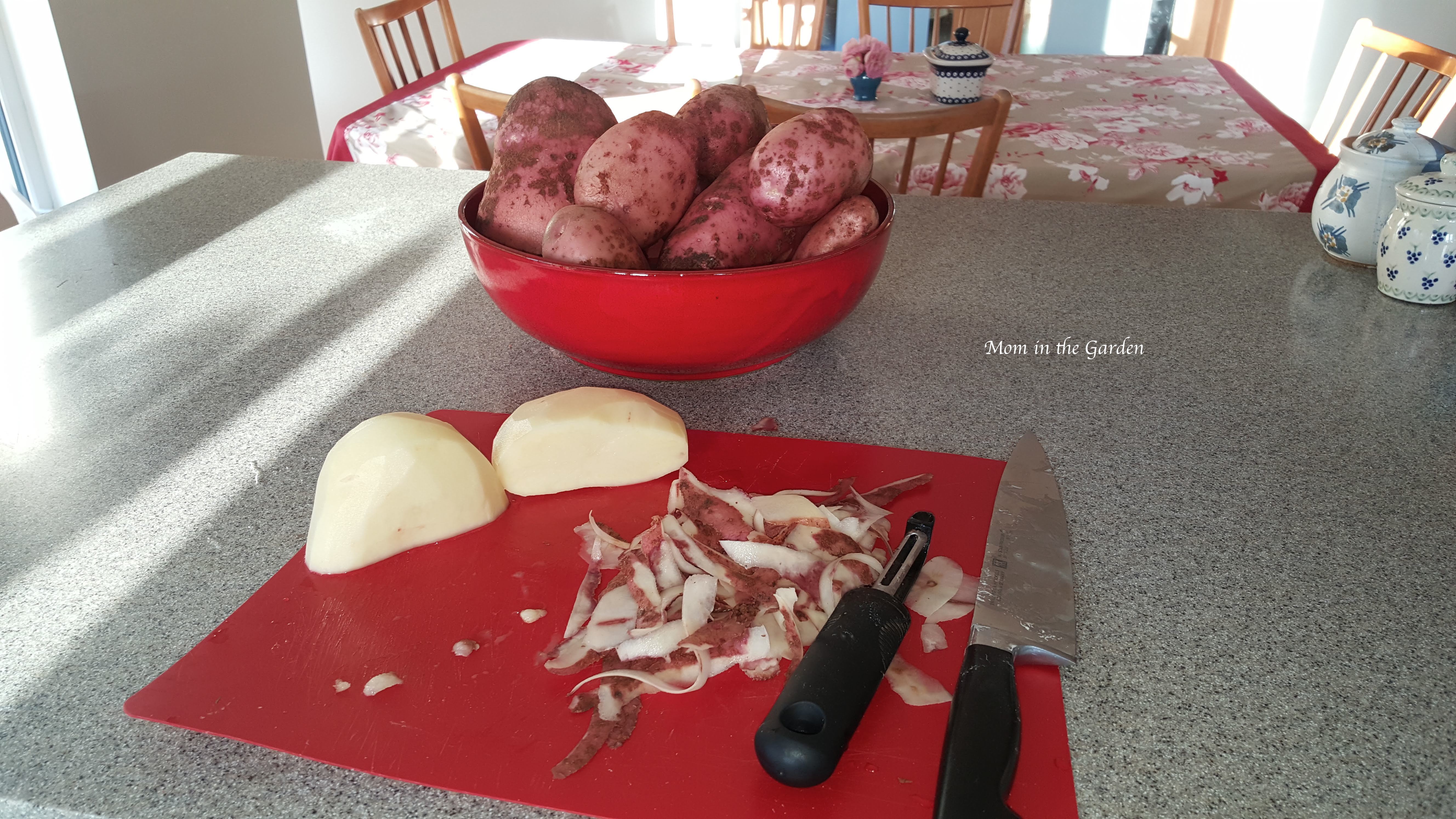 potatoes on cutting board and in a bowl