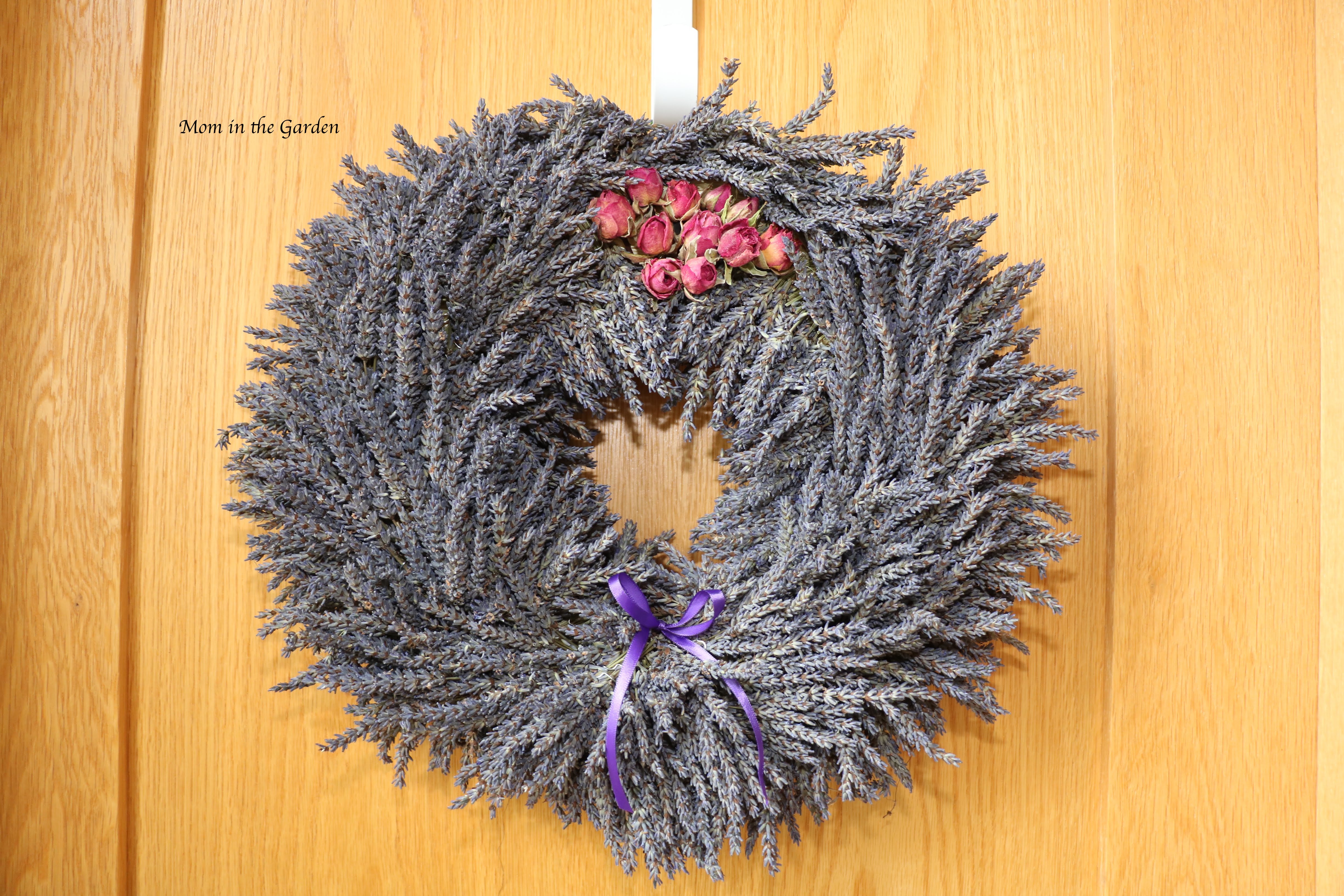 lavender wreath + roses on top + ribbon on door