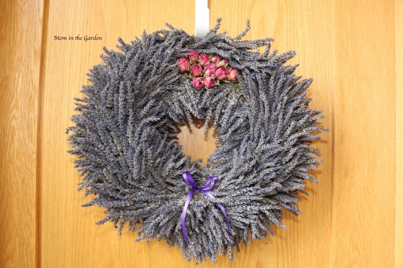 lavender wreath + roses on top + ribbon on door