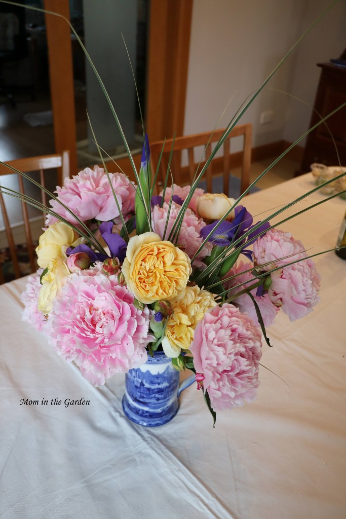 Vase of peony flowers roses and iris