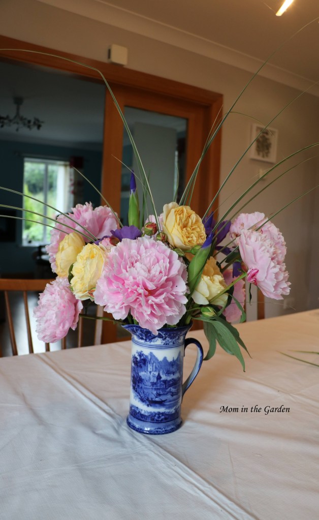 Vase of Peony flowers, roses and Dutch iris