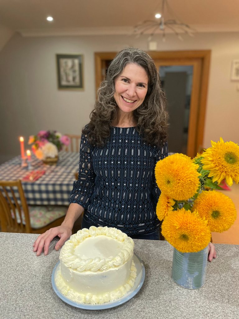 Dana with cake and flowers