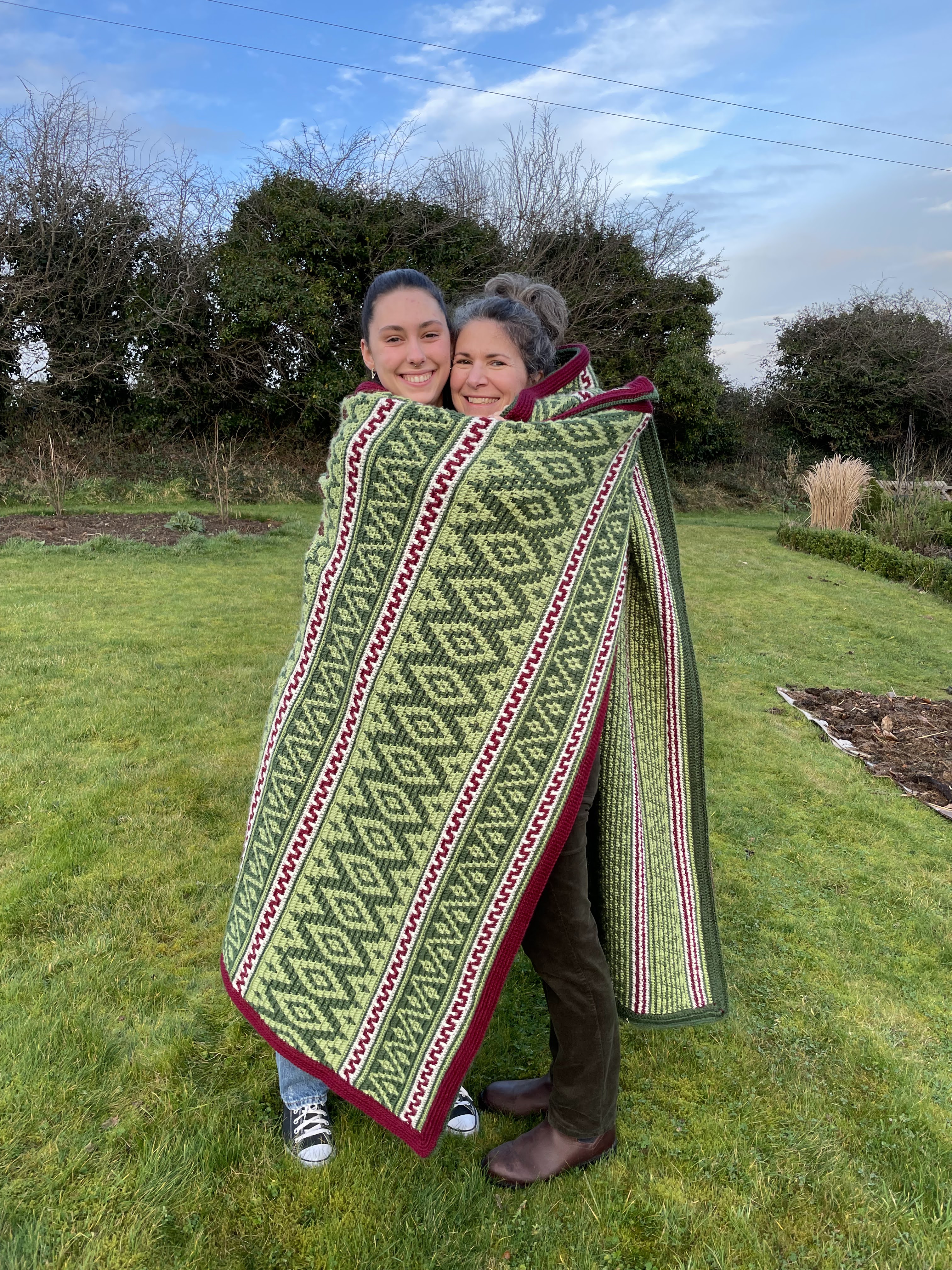 Cliona and Dana wrapped up in the crochet blanket