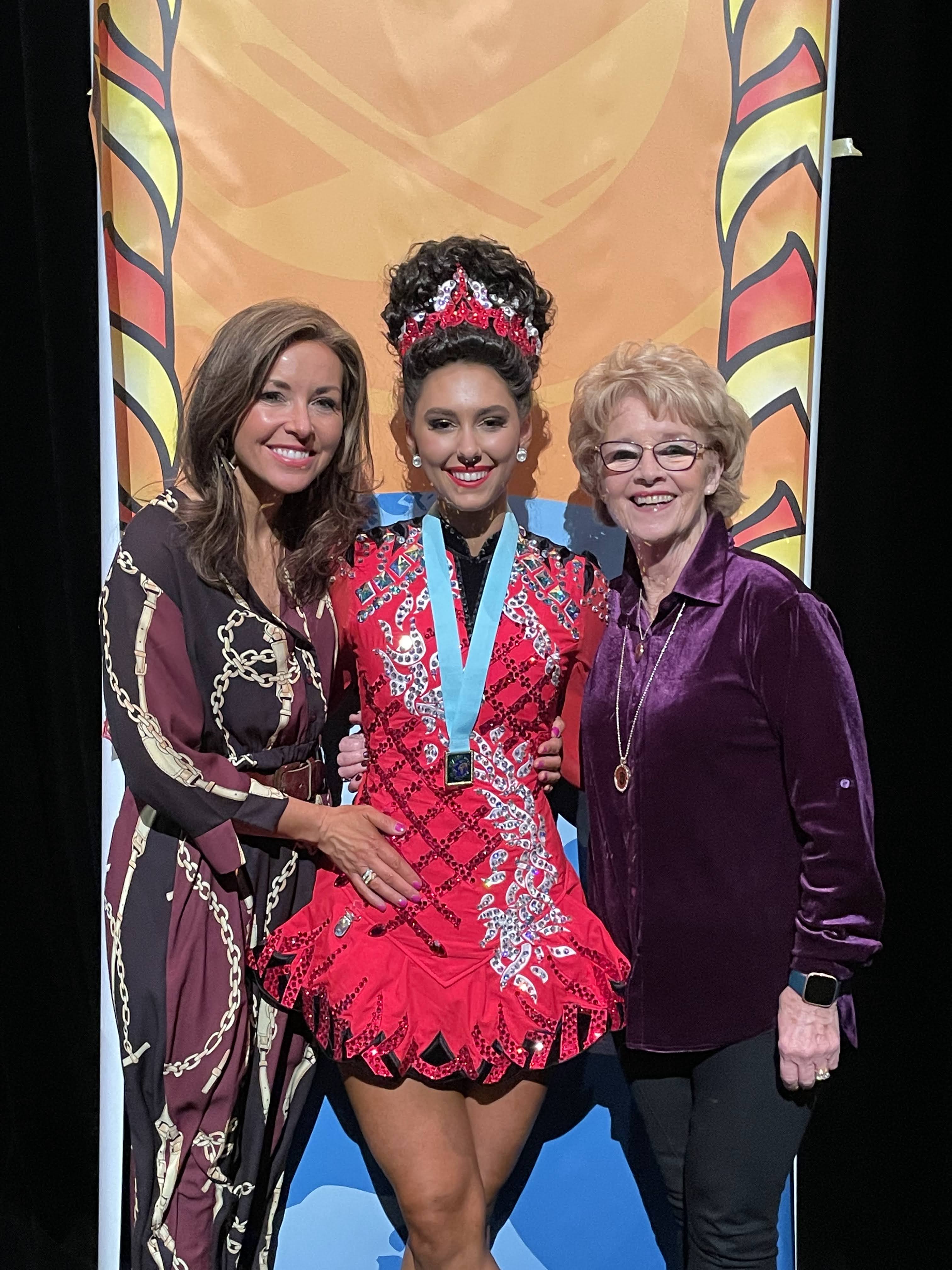 Two of our dance teachers: Ciara Lennon and Mona ni Rodaigh with our dancer, Cliona after getting her second recall medal.